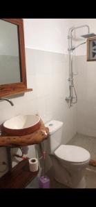 a bathroom with a sink and a toilet at Villa Nemocotier in Cap Skirring