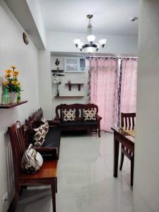 a living room with a couch and a table at Cubao Manhattanheights U24B TD in Manila