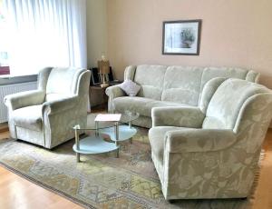 a living room with a couch and two chairs and a table at Gästehaus Braun in Bad König