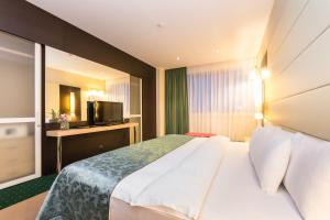 Un pat sau paturi într-o cameră la Mirage Hotel