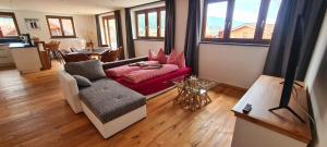 ein Wohnzimmer mit einem Sofa und einem Tisch in der Unterkunft Ferienwohnung mit Sauna am Alpsee in Bühl am Alpsee