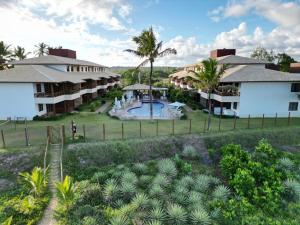 an aerial view of a resort with a swimming pool at Village Beira Mar Itacimirim Boulevard Bahia in Itacimirim