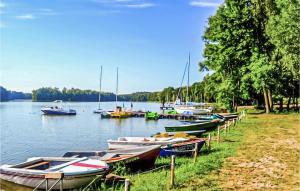 a group of boats parked on the shore of a lake at Nice Home In Biskupiec With House A Panoramic View in Biskupiec