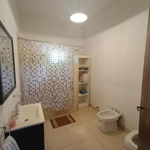 a bathroom with a shower and a toilet and a sink at Los Cardales Mia in Los Cardales