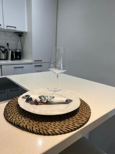 a table with a plate and a wine glass on it at Central Suite Rotterdam in Rotterdam