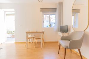 a living room with a table and a mirror at Porto Island in Porto