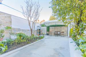 an outdoor patio with a table and chairs at Porto Island in Porto