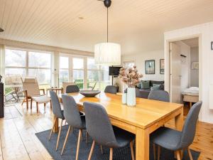 a dining room and living room with a table and chairs at Holiday home Karrebæksminde LIII in Karrebæksminde