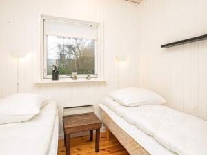 a white bedroom with two beds and a window at 8 person holiday home in Karrebæksminde-By Traum in Karrebæksminde +38 photos