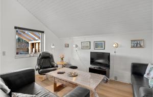 ein Wohnzimmer mit einem Tisch und einem TV in der Unterkunft Pet Friendly Home In Oksbl With Wifi in Oksbøl