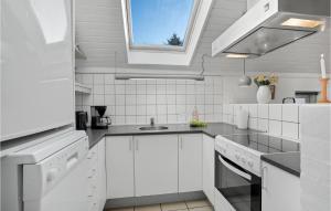 a white kitchen with a sink and a window at Pet Friendly Home In Oksbøl With Wifi in Oksbøl