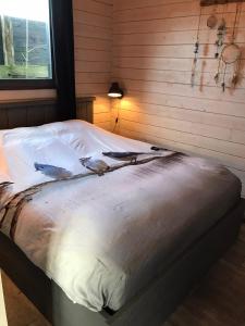 a large bed in a room with a window at Chalet peter in Limmen