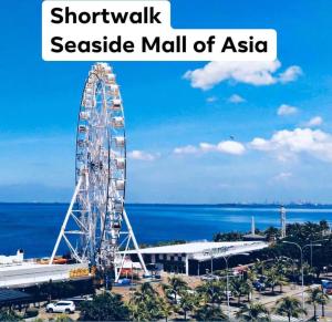 a ferris wheel in a seaside mall of asia at Shell Residences C15 Shortwalk Sm Mall Of Asia/Airport in Manila