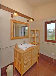 a bathroom with a sink and a mirror at House Josko in Vinišće +30 photos