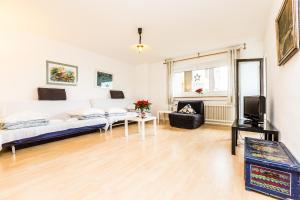 a living room with a couch and a tv at Apartment Köln Neubrück in Cologne