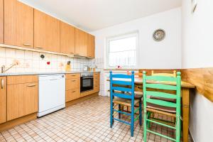 a kitchen with two chairs and a table at Apartment Köln Neubrück in Cologne