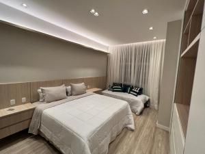 Cama o camas de una habitación en Palácio quitandinha apartamento luxo