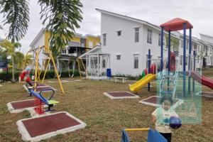 a child playing on a playground in a yard at HYDA Homestay Melaka, Durian Tunggal in Kampong Tengah