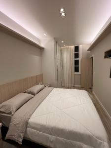 En eller flere senger på et rom på Palácio quitandinha apartamento luxo