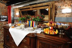 a table with fruit on it with a mirror at Hotel Centrum Sosnowiec in Sosnowiec