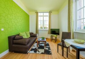 a living room with a couch and a table at Landhaus Christophorus in Forbach