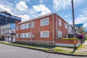 a red brick building on the side of a street at Corazon del Molino Corferias Bogota- Embajada Americana in Bogotá