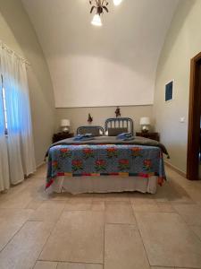 A bed or beds in a room at Masseria I Raffi b&b