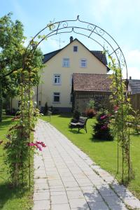 an arch over a walkway in a yard at Hotel Sunnegässle in Rust