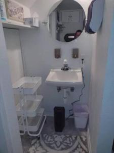 een kleine badkamer met een wastafel en een spiegel bij 2 BR Small Town Rural Setting Personal Fun Arcade in Britt