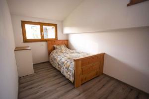 a small bedroom with a bed and a window at Holiday home in Sentvid pri Sticni - Zentralslowenien 43927 in Šentvid pri Stični