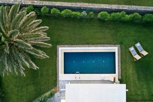 an aerial view of two chairs and a pool at Yria Island Boutique Hotel & Spa in Parasporos