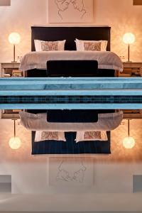 a bedroom with a large bed and a large blue bedvisorvisor at Yria Island Boutique Hotel & Spa in Parasporos