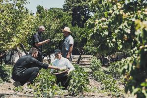 a group of men standing in a vegetable garden at Yria Island Boutique Hotel & Spa in Parasporos