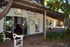a restaurant with a bench in front of a building at Dove's Nest Guest House in Kempton Park