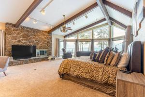 Flathead Lake Villa - Full Property في Lakeside: غرفة نوم بسرير كبير وتلفزيون