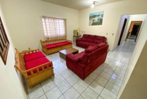 a living room with two red couches at Guest Hostel 2 Marli's in Bonito