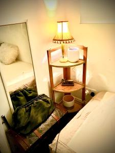 a lamp on a table next to a bed at Hendon Homestay in Hendon