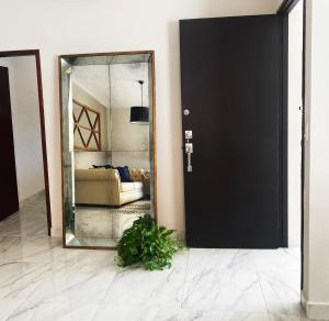 a black door with a mirror in a room at Casa Magnolia 2 in Ciudad Madero