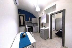 a kitchen with a blue counter top in a room at Apartments Casa Vacanze Dante in Catania