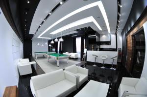a living room with white furniture and a pool table at Alpina Resort by Stellar Hotels, Tsaghkadzor in Tsaghkadzor