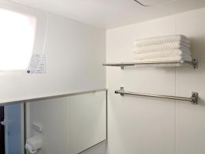 a bathroom with white walls and chrome towel racks at 和縁WAEN in Tokyo +33 photos