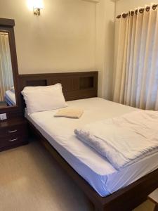 Postel nebo postele na pokoji v ubytování Pokhara Eco Friendly Home