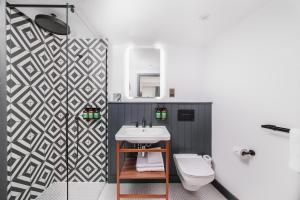 a bathroom with a sink and a toilet at Staybridge Suites Brighton by IHG in Brighton & Hove +60 photos