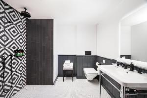 a bathroom with a sink and a toilet at Staybridge Suites Brighton, an IHG Hotel in Brighton & Hove