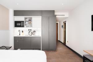 a kitchen with a sink and a counter at Staybridge Suites Brighton by IHG in Brighton & Hove