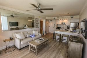 a living room with a couch and a kitchen at Lovers Key Resort 403 in Fort Myers Beach