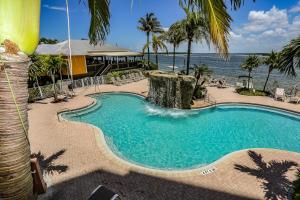 a swimming pool with the ocean in the background at Lovers Key Resort 403 in Fort Myers Beach
