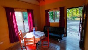 a living room with a table and a couch at Quinta Pehuen in Tortuguitas