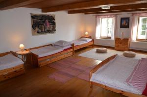 a bedroom with three beds and two windows at Růžová chalupa u Šimánků in Rtyně v Podkrkonoší +63 photos