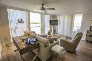 a living room with a couch and a table at Lovers Key Resort 404 in Fort Myers Beach